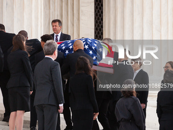 The flag-draped casket of Associate Justice Sandra Day O’Connor, the first woman to serve on the Supreme Court, passes between two lines of...