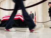 A person walks by the casket of retired Associate Justice Sandra Day O’Connor, the first woman to serve on the Supreme Court, after paying t...