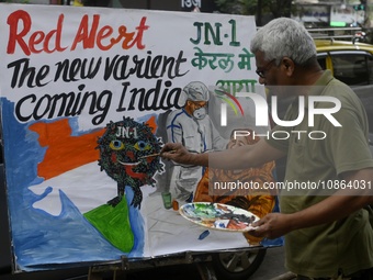 A teacher from a drawing academy is painting posters to raise awareness about the ongoing surge of the JN.1 Covid-19 variant, which is sprea...