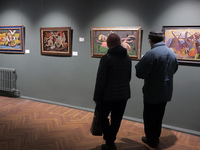 Visitors are looking at paintings displayed at the Odesa National Fine Arts Museum, which has reopened after the Russian missile attack on N...
