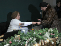 A visitor is buying a ticket as the Odesa National Fine Arts Museum reopens after the Russian missile attack on November 5, in Odesa, Ukrain...