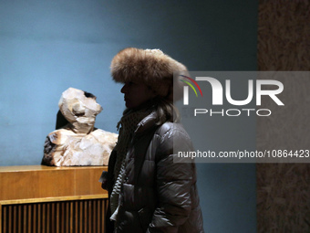 A visitor is walking past a wooden bust as the Odesa National Fine Arts Museum reopens after the Russian missile attack on November 5, in Od...