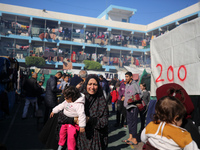 Displaced Palestinians are taking shelter in a UNRWA-affiliated Deir al-Balah school after fleeing their homes due to Israeli strikes, amid...