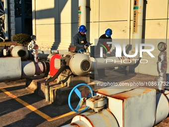 A staff member of a thermal power company is performing anti-freeze maintenance on mechanical and electrical equipment in a cooling zone in...
