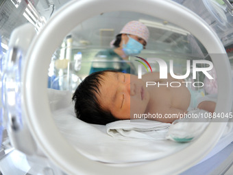 A medical worker is taking care of newborns at Dongfang Hospital in Lianyungang, China, on January 1, 2024. (
