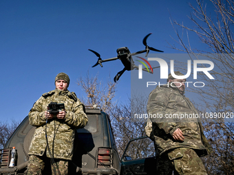 Servicemen from an artillery unit of the 128th Mountain Assault Brigade of the Ukrainian Ground Forces are training to use a drone during a...