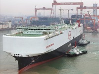 The large car carrier BYD Explorer 1 is being assisted by a tugboat at CIMC Raffles' Shandong Longkou construction base in Yantai, China, on...
