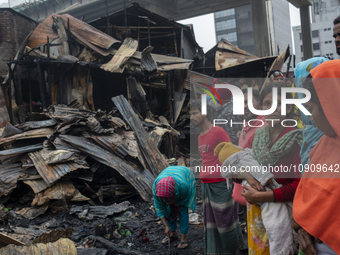 Slum-dwellers are searching for their household belongings following a devastating fire that broke out at the Karwan Bazar slum in Dhaka, Ba...