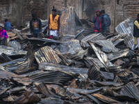 Slum-dwellers are searching for their household belongings following a devastating fire that broke out at the Karwan Bazar slum in Dhaka, Ba...