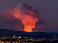 A volcano is spewing lava and smoke as it erupts in Reykjanes Peninsula, Iceland, on January 14, 2024. The volcanic eruption, which occurred...