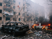 Cars are burning next to the site where the rocket struck, in Kharkiv, Ukraine, on January 23, 2024. On The Morning Of January 23, 2024, Rus...