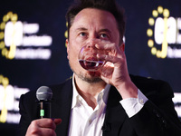 Elon Musk, owner of Tesla and the X (formerly Twitter) platform, is drinking water while attending a symposium on fighting antisemitism titl...
