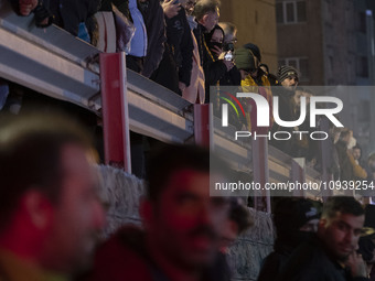 People are watching while standing at the site of the fire at the Gandhi hotel hospital in northern Tehran, Iran, on January 25, 2024. Patie...