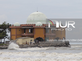Residents are leaving the mosque after performing Friday prayers amidst high waves in Cemarajaya Village, Karawang Regency, West Java Provin...