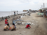 Children are playing on the village street right on the beach in Cemarajaya Village, Karawang Regency, West Java Province, on January 26, 20...