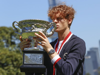 Jannik Sinner of Italy is posing with the Norman Brookes Challenge Cup after winning the 2024 Australian Open Final at the Royal Botanic Gar...