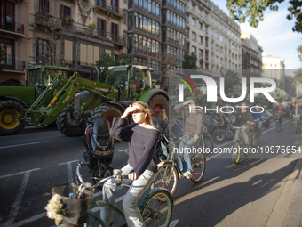 A group of cyclists is advancing ahead of the blockade in Barcelona, Spain, on February 7, 2024, as thousands of tractors block the city cen...