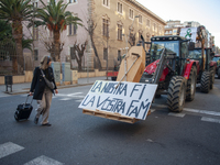 A tourist is reading the banner ''Our end is your hunger'' in Barcelona, Spain, on February 7, 2024. In light of the protests occurring acro...
