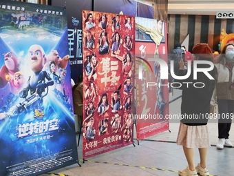 Citizens are passing movie posters at a cinema in Shanghai, China, on February 10, 2024. (