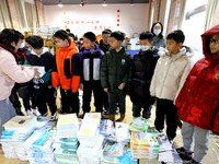 Students are receiving new textbooks at Yuanqian Primary School in Lianyungang, China, on February 20, 2024. (