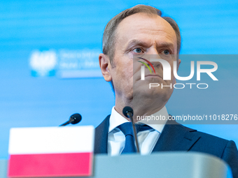 Polish Prime Minister Donald Tusk is speaking during a press conference after his meeting with Belgian Prime Minister Alexander De Croo and...