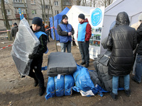 Volunteers are helping locals near a block of flats in Dnipro, Ukraine, on February 23, 2024, that was hit by a Russian Shahed drone during...