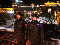 Police officers are on duty at the Tanguo Ancient City scenic spot in Linyi, China, on February 23, 2024. (