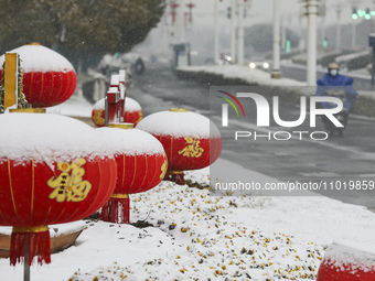 A traffic policeman is braving the snow while on duty at a junction in Huai'an, China, on February 24, 2024. (