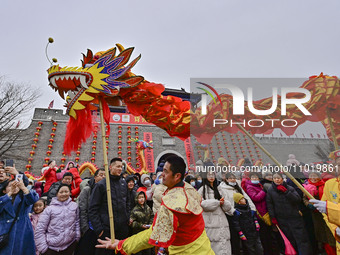 Folk artists are performing a dragon dance at the Ancient City scenic spot in Qingzhou, Shandong Province, China, on February 24, 2024. (