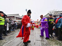 Folk artists are performing traditional folk customs at the Ancient City scenic spot in Qingzhou, Shandong Province, China, on February 24,...