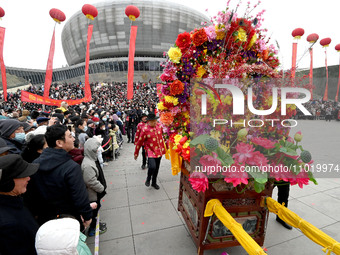 Folk artists are performing the Lifting Flower Table in Handan, Hebei Province, China, on February 24, 2024. (