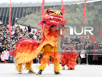 Folk artists are performing a lion dance in Handan, North China's Hebei province, on February 24, 2024. (