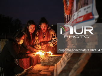 Families of a deceased Nepali citizen, who was fighting for Russia, are lighting lamps during a vigil ceremony in Kathmandu, Nepal, on Febru...