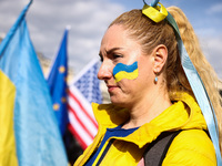 A woman attend the march ' Together For Victory ' to show solidarity with Ukraine and commemorate two year anniversary of Russian invasion o...
