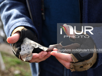 A man is holding a drone fragment after the Russian overnight drone attack in Odesa, Ukraine, on February 24, 2024. (