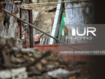 A senior woman is examining a house after the Russian overnight drone attack in Odesa, Ukraine, on February 24, 2024. (
