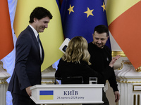 Ukrainian President Volodymyr Zelenskiy, Italian Prime Minister Giorgia Meloni, and Canadian Prime Minister Justin Trudeau are standing toge...