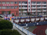 Primary school students are lining up to enter the campus at the start of the new semester in Yichang, Hubei Province, China, on February 26...