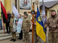 Soldiers are holding a portrait of the serviceman Roman Kornuta (call sign ''Mazepa''), who died in the war with Russia, during a farewell c...