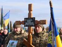 Soldiers are holding a portrait of Roman Kornuta (call sign ''Mazepa''), who died in the war with Russia, during a farewell ceremony in Chuk...