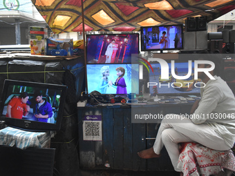A person is selling second-hand LCD TV sets inside a second-hand electronics market in Kolkata, India, on February 26, 2024. (