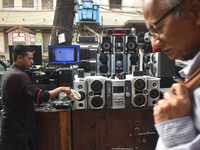 A person is selling second-hand music systems at a second-hand electronics market in Kolkata, India, on February 26, 2024. (