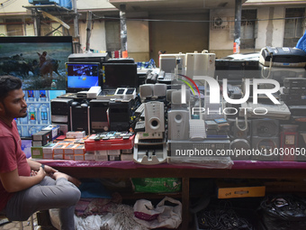 A person is selling second-hand electronic gadgets inside a second-hand electronics market in Kolkata, India, on February 26, 2024. (