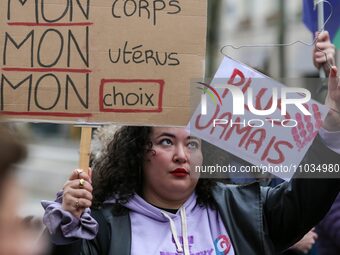 A protester is holding a sign that reads ''My body, My uterus, My choice'' during a silent gathering at Place de la Sorbonne, organized by t...