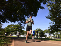 People are practicing physical activity and amateur runners are running in the Dona Sarah Kubitschek City Park in Brasilia, Brazil, on a sun...