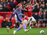 Alexis Mac Allister of Liverpool is battling with Taiwo Awoniyi of Nottingham Forest during the Premier League match between Nottingham Fore...