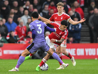 Wataru Endo of Liverpool is battling with Morgan Gibbs-White of Nottingham Forest during the Premier League match between Nottingham Forest...