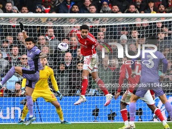 Andrew Omobamidele of Nottingham Forest is heading the ball during the Premier League match between Nottingham Forest and Liverpool at the C...