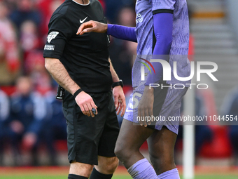 Referee Paul Tierney is checking on Ibrahima Konate of Liverpool after he clashed with Liverpool goalkeeper Caoimhin Kelleher during the Pre...