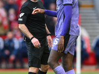 Referee Paul Tierney is checking on Ibrahima Konate of Liverpool after he clashed with Liverpool goalkeeper Caoimhin Kelleher during the Pre...